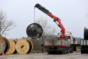 Hiab in use, loading up a large bail of power cable